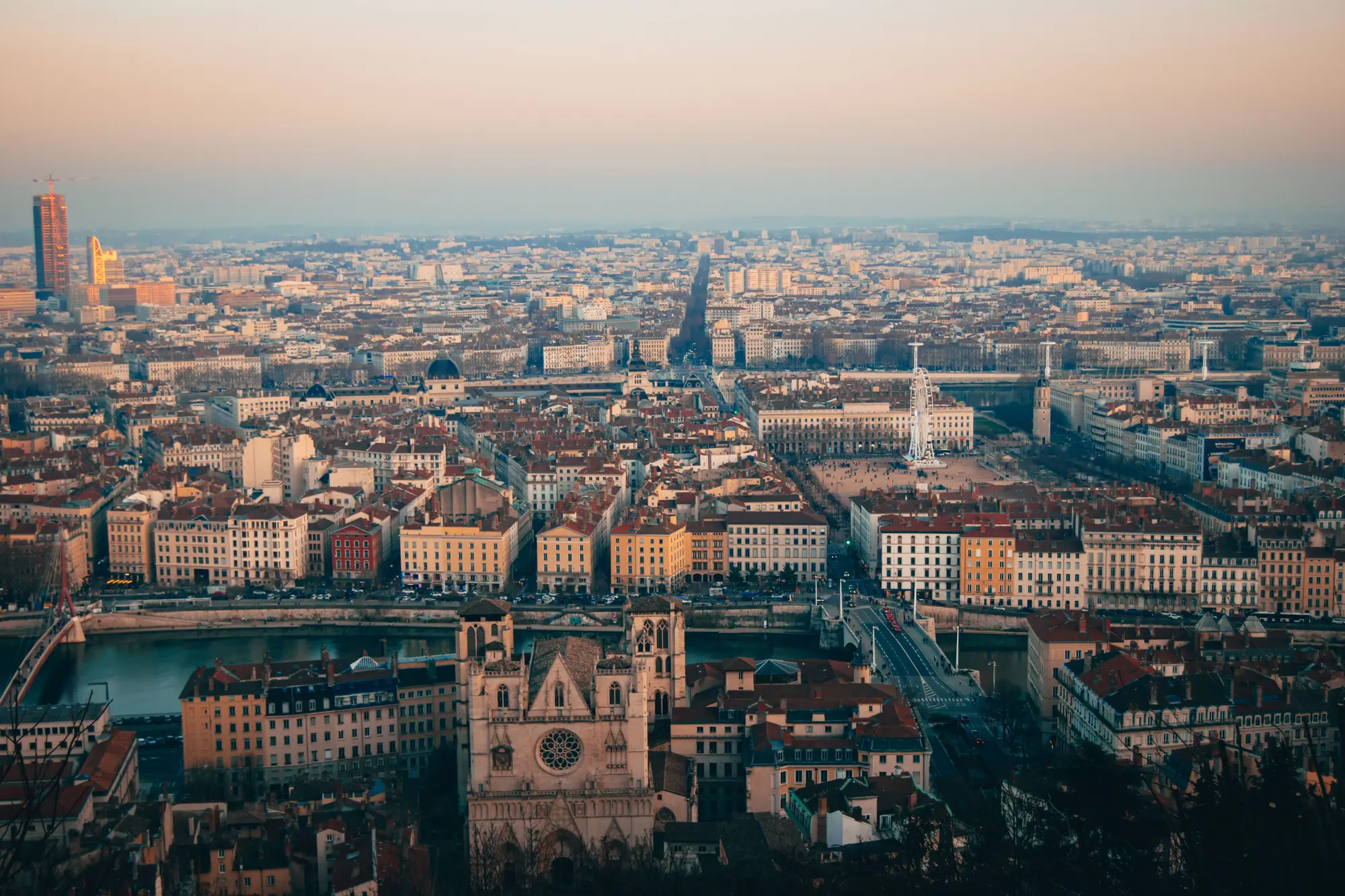 Lyon at sunset from above, with the Saône and the old town below the hill.